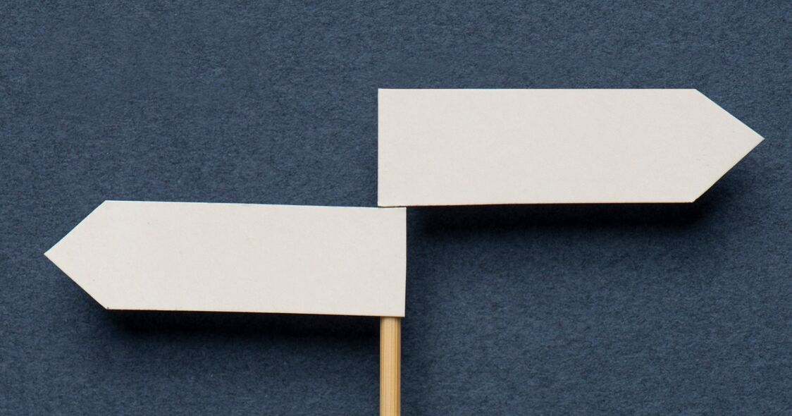 a placard with two opposing direction markers